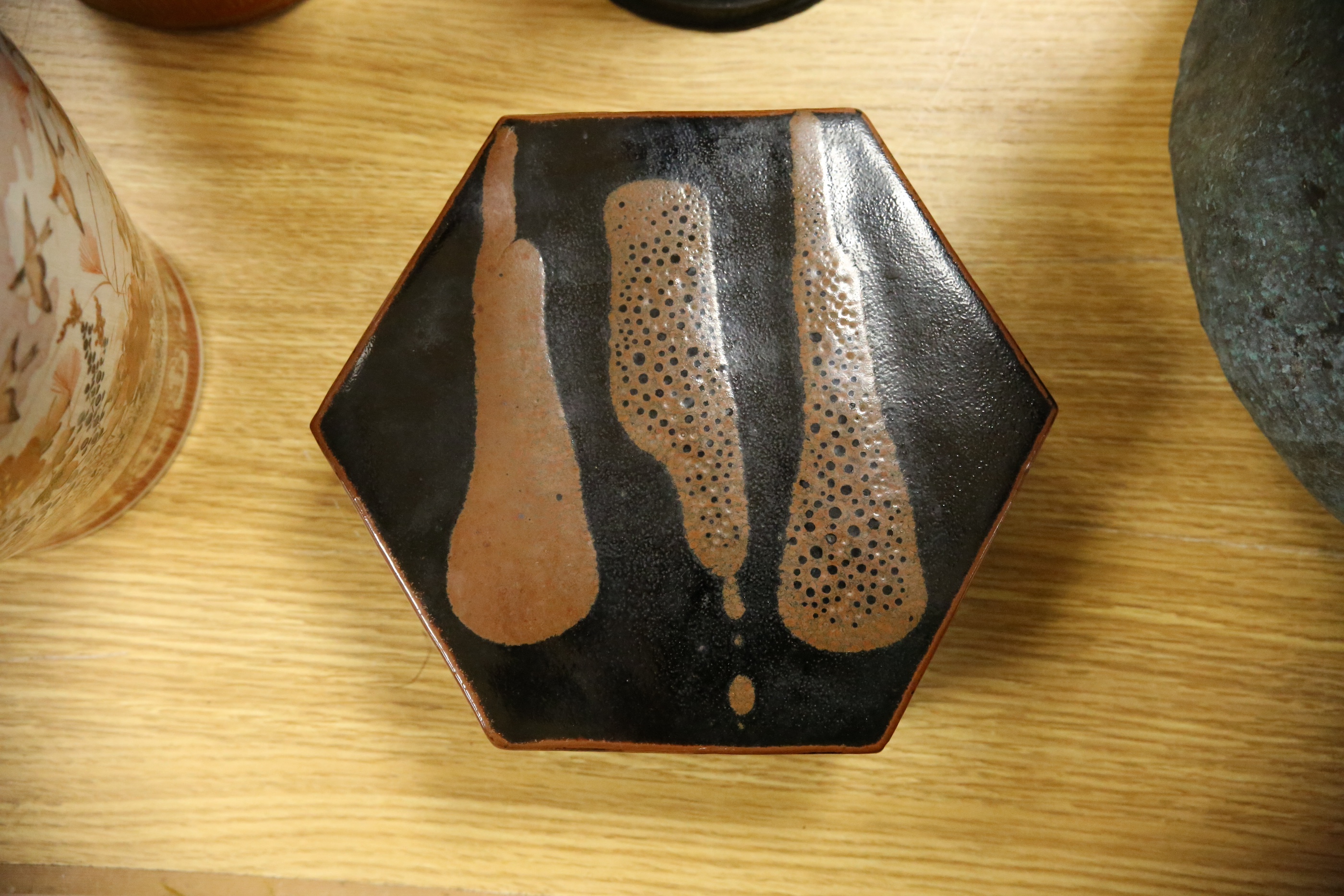 A Japanese studio tenmoku glazed hexagonal box and cover, unmarked, 18cm wide. Condition - good